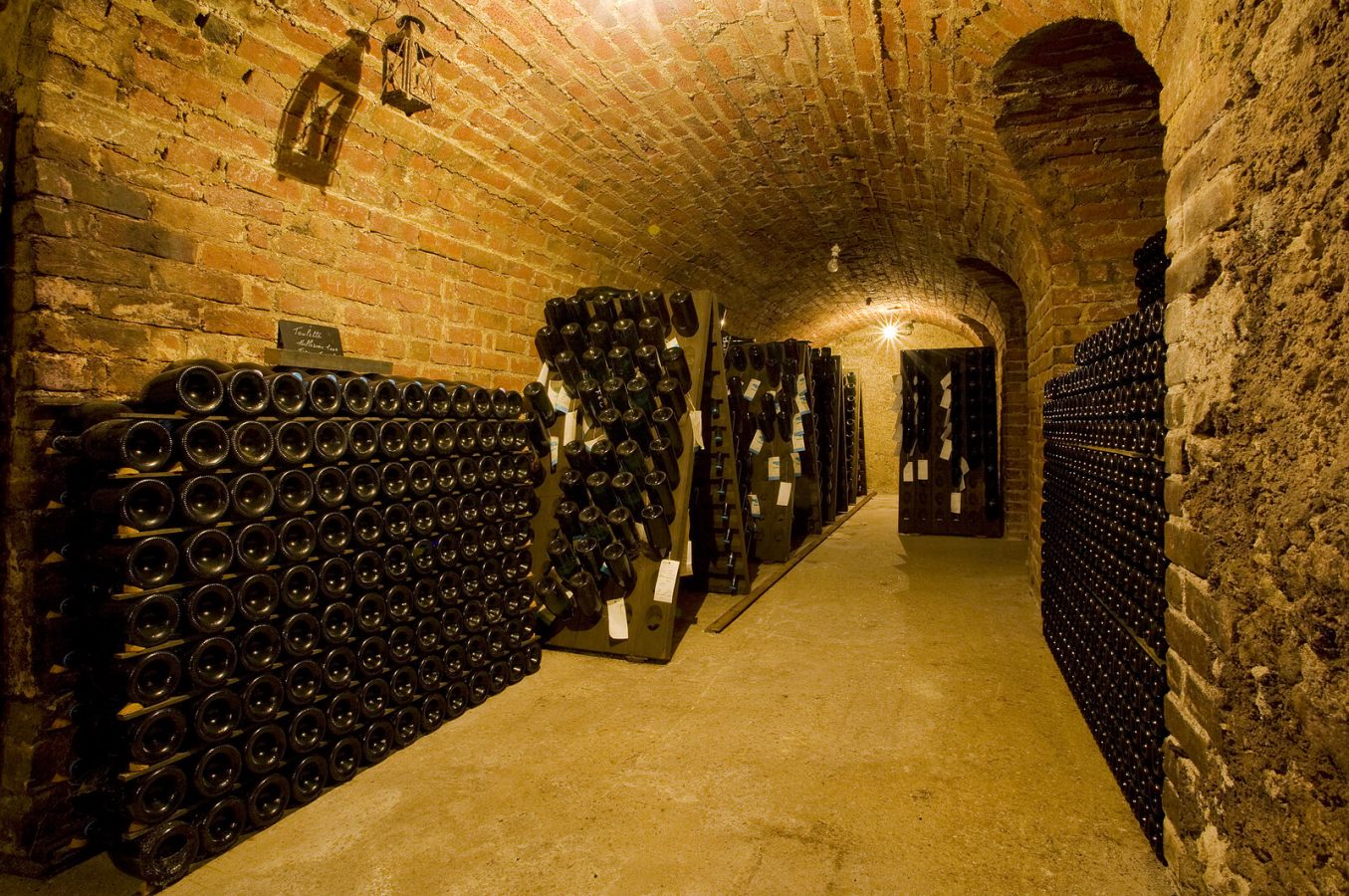 Wine bottles aging in historic brick-lined cellar in Istria, Croatia